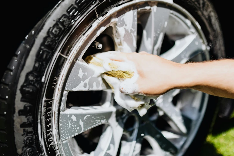 a person washing a tire with a sponge, pexels contest winner, 💋 💄 👠 👗, ultradetailled, paws on wheel, profile image