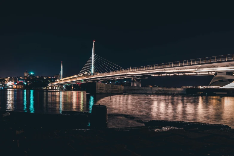 a bridge over a body of water at night, by Adam Szentpétery, pexels contest winner, broad detail, lightweight, unsplash 4k, maintenance photo