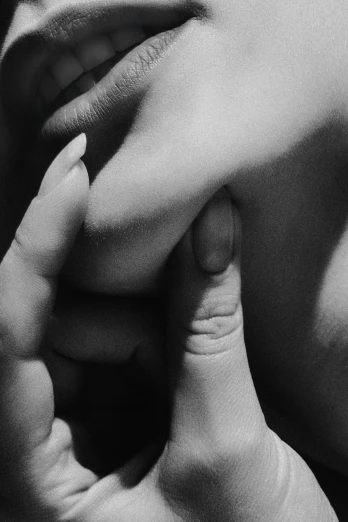 a black and white photo of a woman's face, a black and white photo, inspired by Germaine Krull, unsplash, photorealism, holding hands, guy bourdin, finger, cuddling