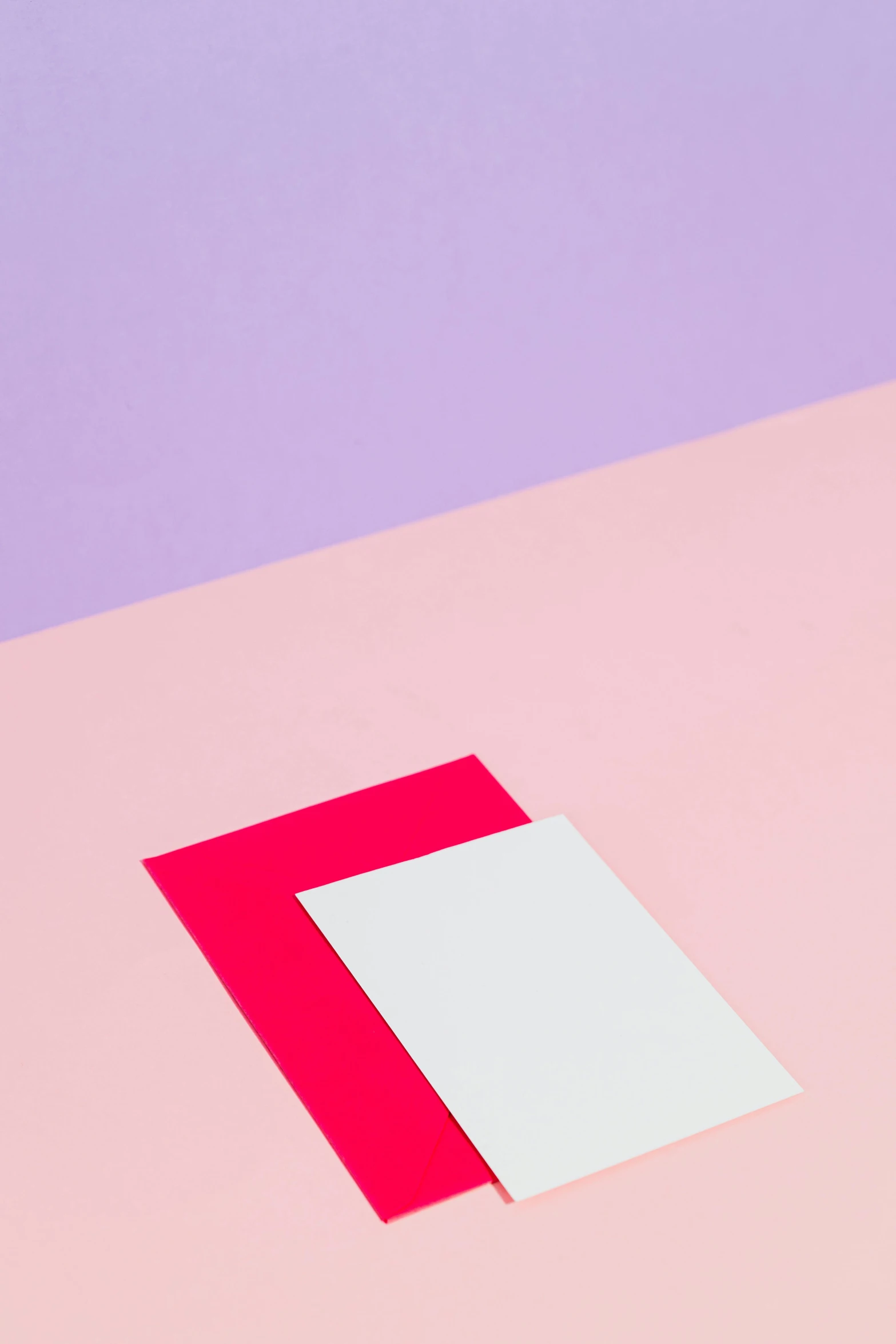 a piece of paper sitting on top of a table, inspired by Josef Albers, trending on unsplash, color field, pink and purple, graphic detail, vertical composition, pink and red color style