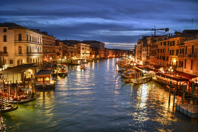 a canal filled with lots of boats next to tall buildings, inspired by Quirizio di Giovanni da Murano, pexels contest winner, renaissance, evening lighting, square, venice biennale's golden lion, grain”