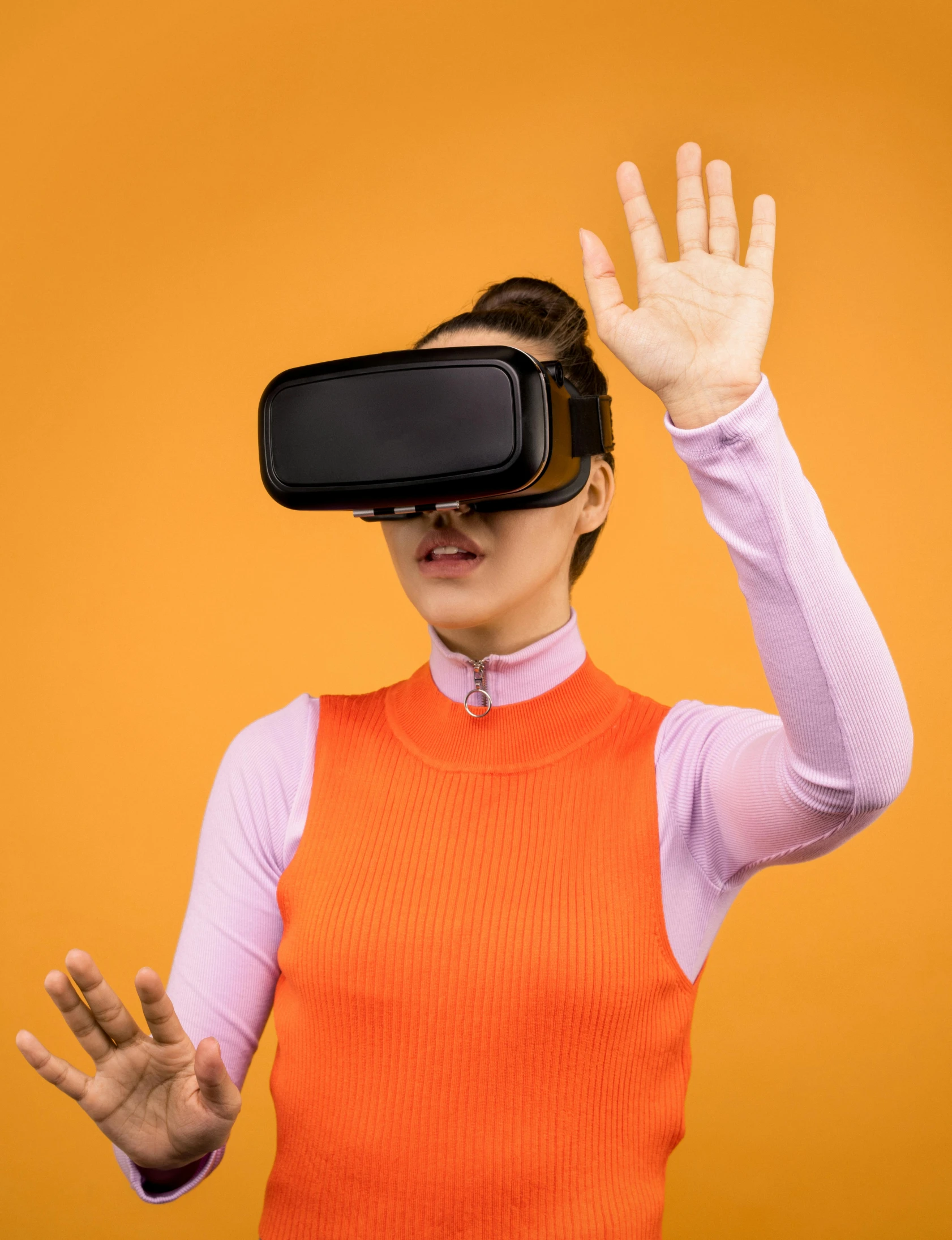 a woman wearing a virtual reality headset, by Julia Pishtar, hypermodernism, in front of an orange background, wave a hand at the camera, model is wearing techtical vest, promotional image