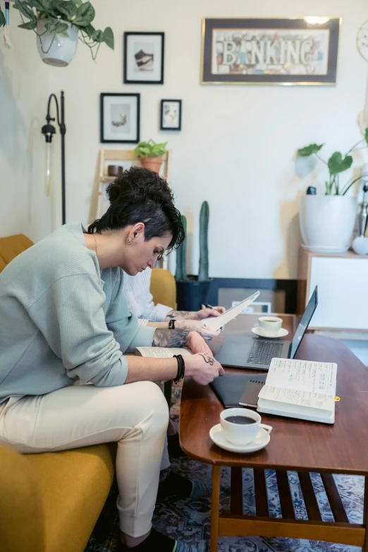 a man sitting on a couch working on a laptop, by Miyamoto, pexels contest winner, happening, yoshitomo nara and aya takano, sitting on a mocha-colored table, profile image, small room in tokyo