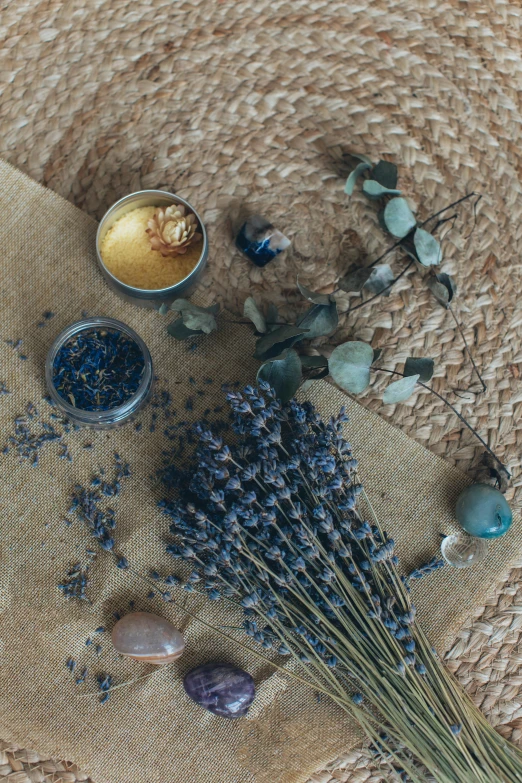 a bunch of dried flowers sitting on top of a table, sapphire, natural materials, lavender, skincare
