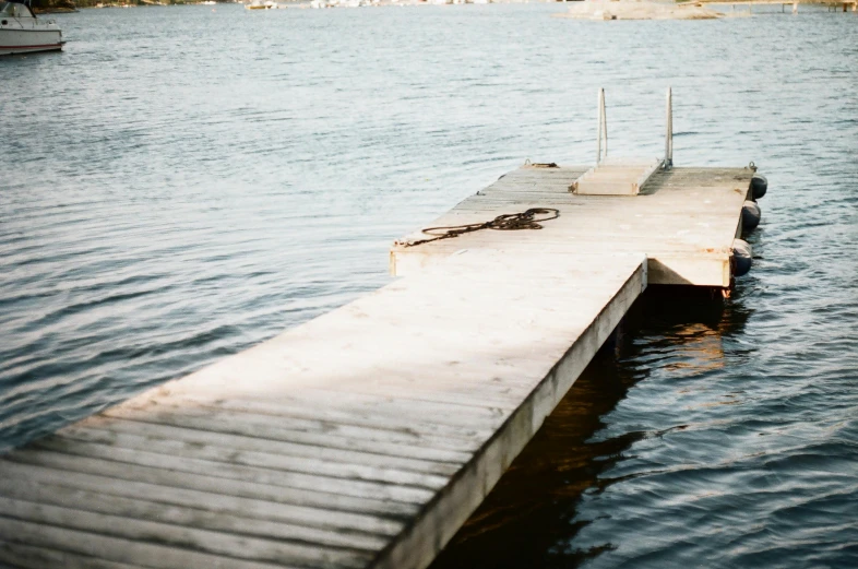 a dock in the middle of a body of water, a picture, by Jaakko Mattila, unsplash, hurufiyya, alvar aalto, 3 5 mm still photo, romantic lead, emily rajtkowski