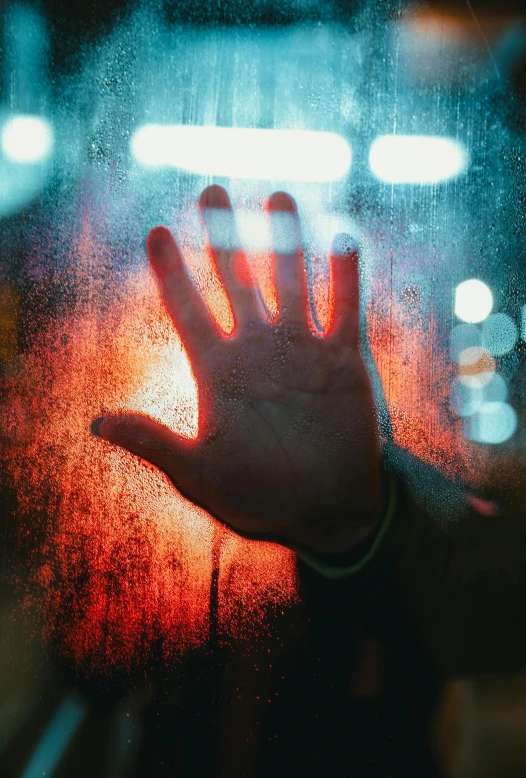 a person holding their hand up in front of a window, a picture, inspired by Elsa Bleda, trending on pexels, graffiti, darkness aura red light, frosted glass, transplanted hand to head, sad look