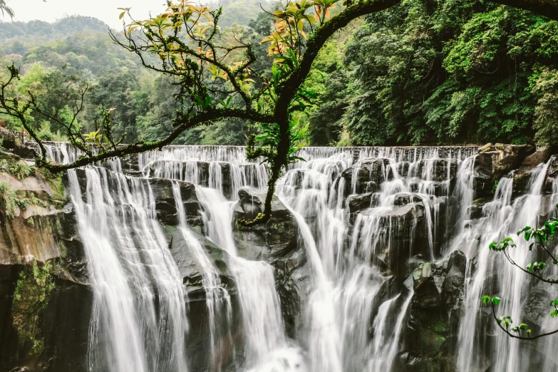 a waterfall in the middle of a forest, by Yasushi Sugiyama, pexels contest winner, hurufiyya, guangjian huang, one million lave rivers, well preserved, 2000s photo