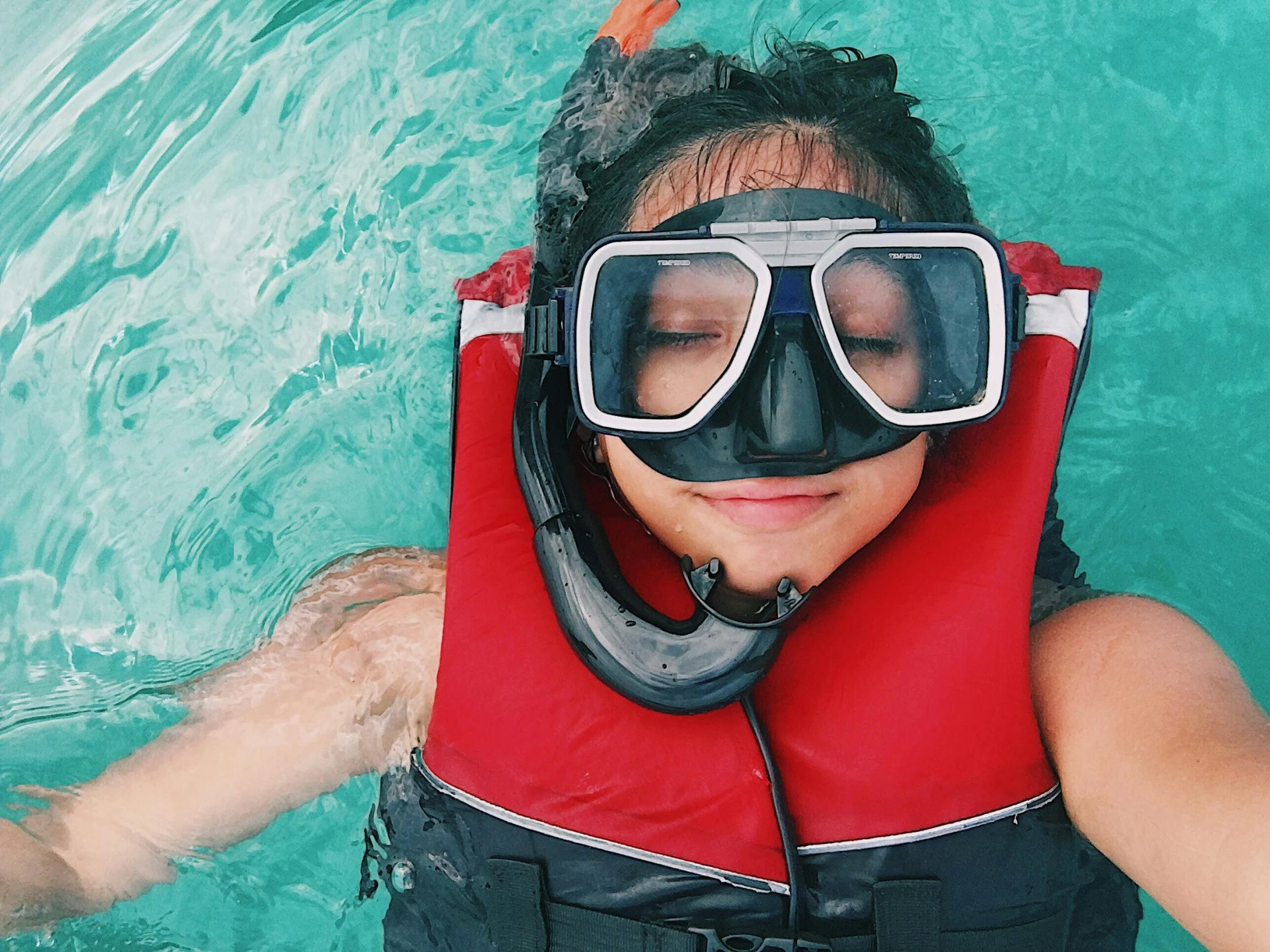 a close up of a person in a body of water, a picture, goggles, inflatable, thumbnail, turquoise water