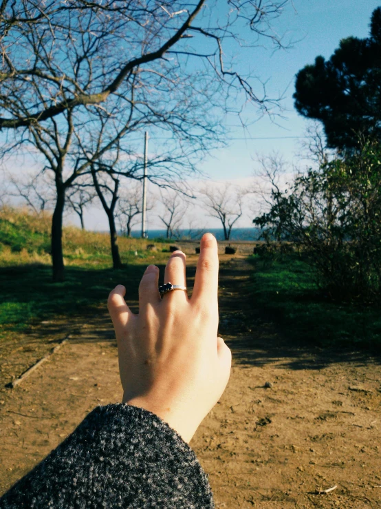 a close up of a person's hand reaching for a frisbee, by Lucia Peka, kamakura scenery, ring, ✨🕌🌙, panoramic view of girl