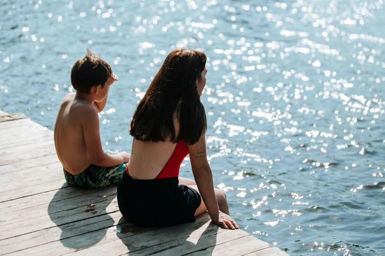 a couple of people that are sitting on a dock, kids, profile image, people swimming, sunny afternoon