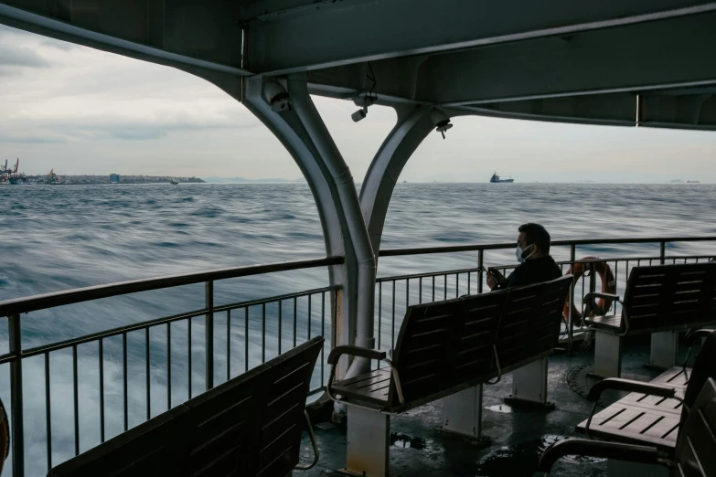 a person sitting on a bench on a boat, by Elsa Bleda, pexels contest winner, realism, shipfleet on the horizon, seattle, black sea, slide show