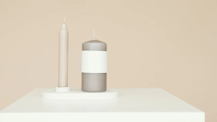 a couple of candles sitting on top of a table, minimalism, taupe, opaque, soft white rubber, o'neill cylinder