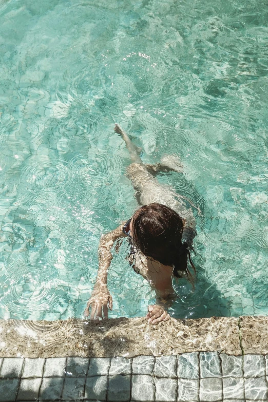 a person swimming in a pool with a frisbee, inspired by Elsa Bleda, pexels contest winner, renaissance, brunette, teal aesthetic, back facing, tan skin