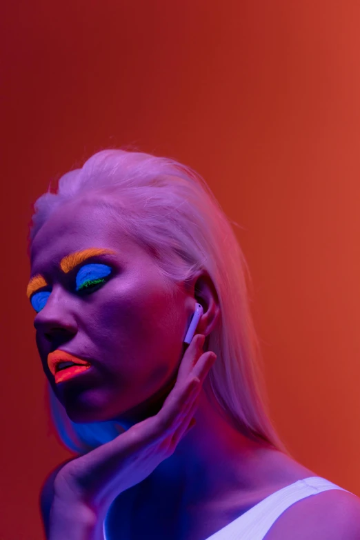 a woman with neon makeup in front of a red background, an album cover, inspired by Elsa Bleda, trending on pexels, girl with white hair, lit up in a dark room, profile pic, neon cybernetic implants