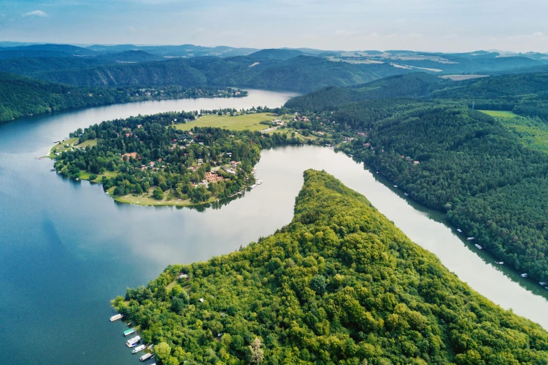 a large body of water surrounded by trees, by Josef Navrátil, pexels contest winner, flying islands, slovakia, istock, maintenance photo