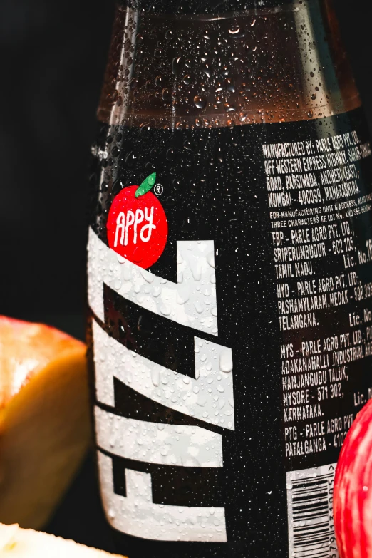 a bottle of soda sitting next to an apple, inspired by Heinz Anger, pexels contest winner, close up shot from the side, buzzed sides, pepperoni, front label