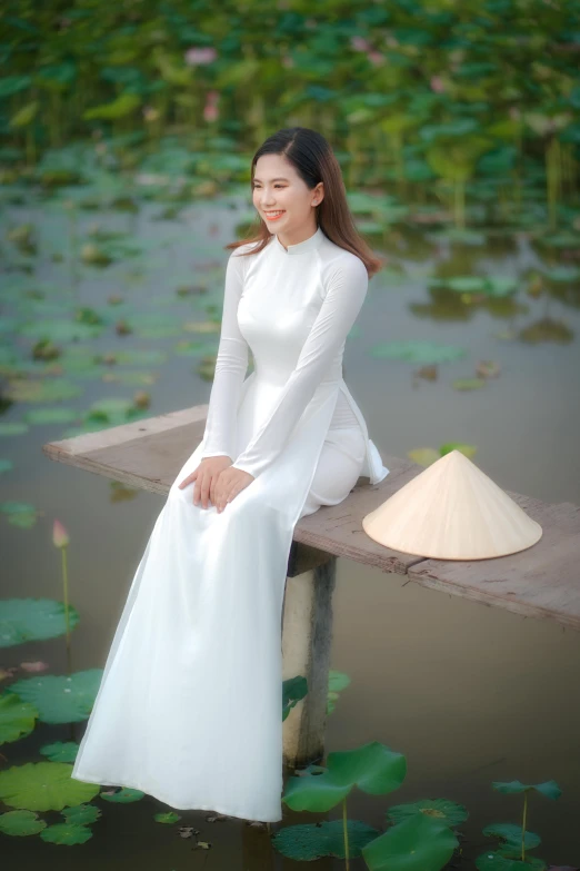 a woman in a white dress sitting on a wooden bench, ao dai, standing on a lotus, promo image, 8 k )