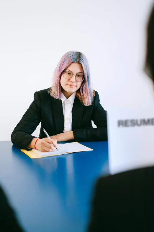 a woman sitting at a table with a resume in front of her, pexels contest winner, two different characters, female in office dress, non-binary, 15081959 21121991 01012000 4k