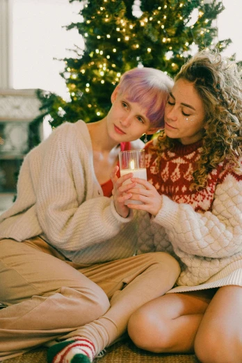 two women sitting on the floor next to a christmas tree, trending on pexels, renaissance, drink milkshakes together, lesbian embrace, lilac hair, on a candle holder