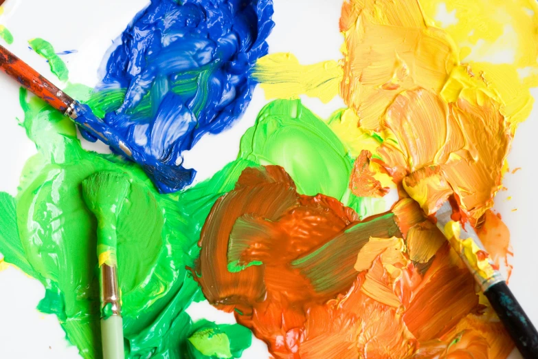 a close up of a palette with paint on it, inspired by Hans Hofmann, trending on pexels, children's artwork, painted with colour on white, brand colours are green and blue, art materials