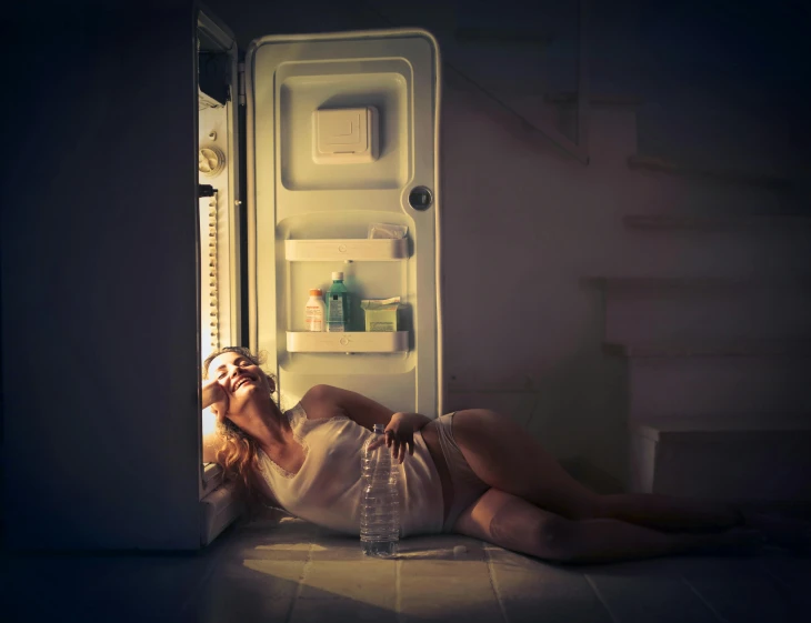 a woman laying on the floor in front of an open refrigerator, inspired by Elsa Bleda, pexels contest winner, scary night, miss aniela, night light, unhappy