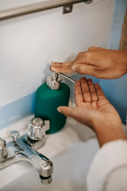 a person washing their hands in a sink, a colorized photo, pexels contest winner, fan favorite, hydration, instagram post, surgical supplies