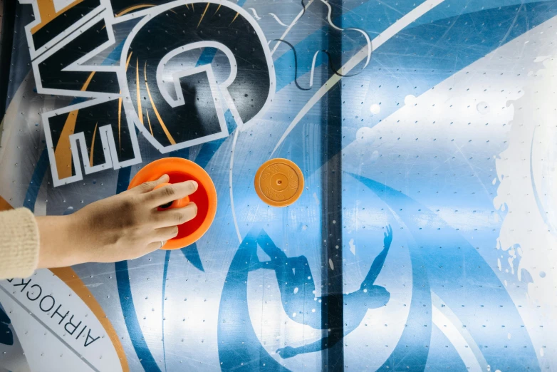 a close up of a person playing with a frisbee, interactive art, orange and cyan paint decals, nhl, smooth marble surfaces, thumbnail