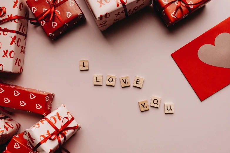 a pile of wrapped presents sitting on top of a table, by Julia Pishtar, trending on pexels, letterism, i love you, red theme, avatar image