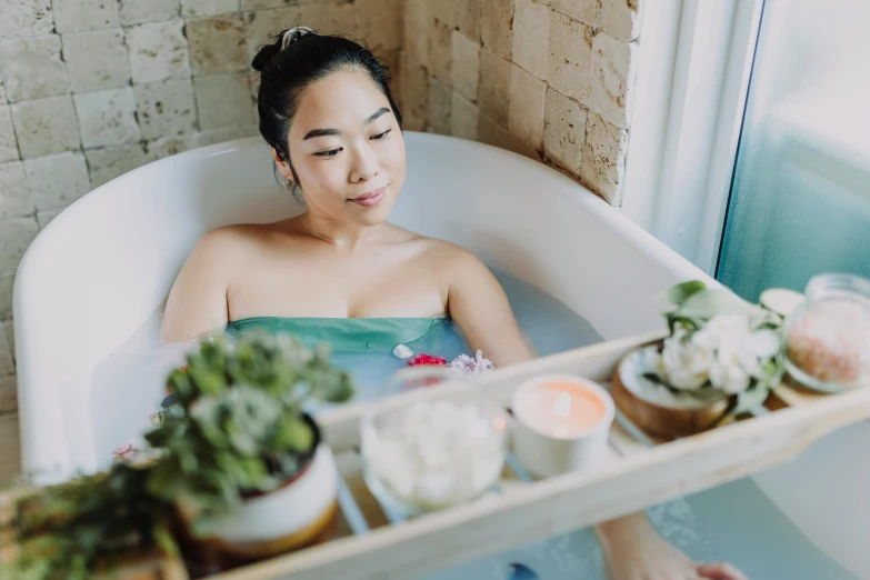 a woman taking a bath in a bathtub, pexels contest winner, asian female water elemental, avatar image, manuka, bumpy skin