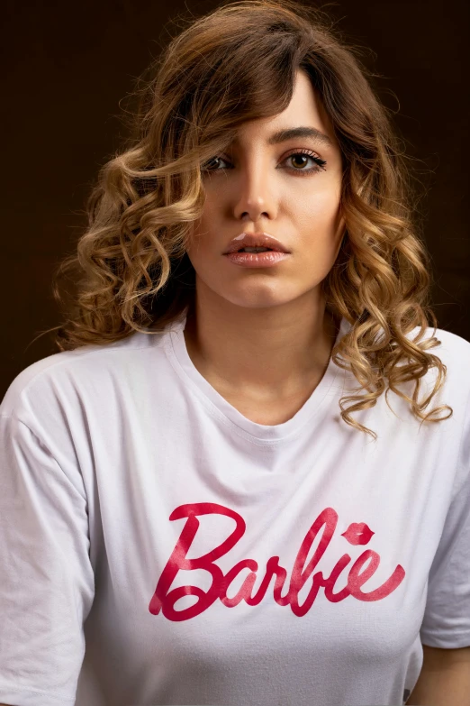 a woman wearing a white shirt with the word barbie on it, by Gabriel Ba, pokimane, middle eastern, portrait image, woman in streetwear