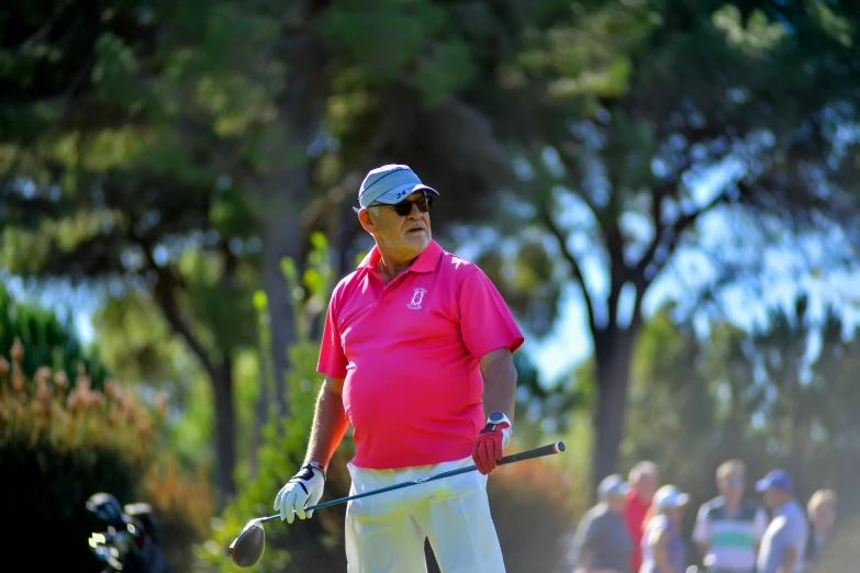 a man in a pink shirt holding a golf club, happening, avatar image, edin durmisevic, wearing sunglasses and a cap, nature photo