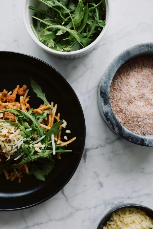 a close up of a plate of food on a table, trending on unsplash, magnesium, eating spaghetti from a bowl, salt, laos