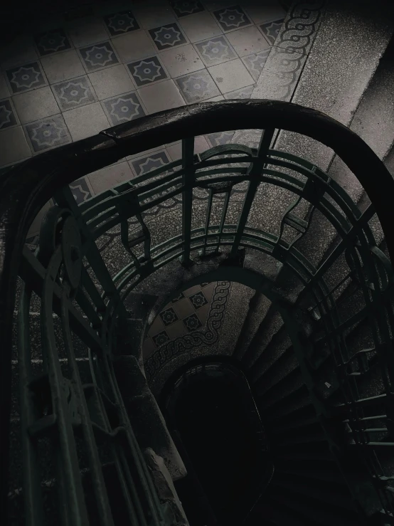 a black and white photo of a spiral staircase, inspired by Elsa Bleda, unsplash contest winner, art nouveau, dark green tones, ✨🕌🌙, horror aesthetic, stairs to an upper floor