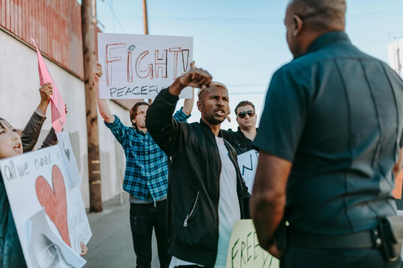 a group of people holding signs on a street, a photo, pexels, black arts movement, jesse pinkman, getting ready to fight, profile image, teddy fresh