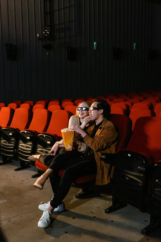a man and a woman sitting in a movie theater