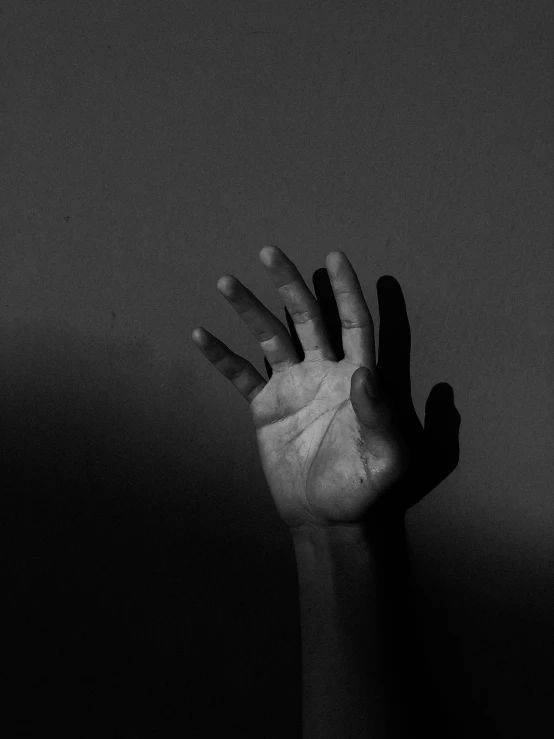 a black and white photo of a hand reaching up, by Adam Chmielowski, pexels, visual art, with a hurt expression, shadowed, ilustration, nika maisuradze