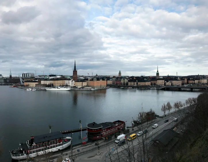 a large body of water next to a city, a picture, by Tom Wänerstrand, stockholm, slight overcast weather, brown, unedited