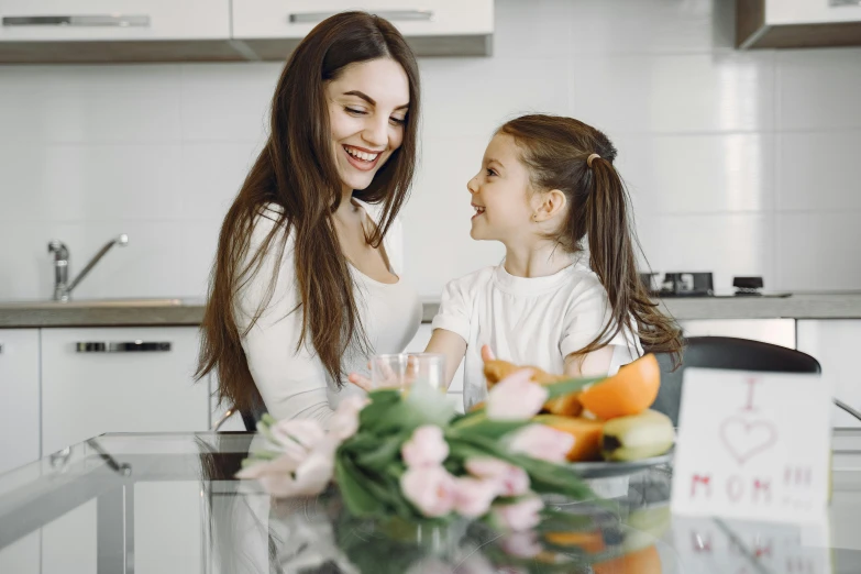 a woman and a little girl sitting at a kitchen table, pexels contest winner, avatar image, brunette, 1 4 9 3, unique design