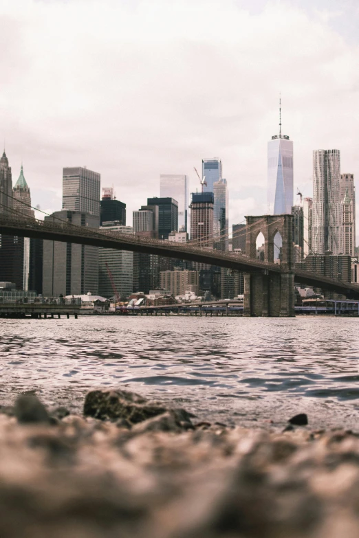 a view of a bridge over a body of water, inspired by Thomas Struth, pexels contest winner, modernism, new york skyline, a messy, a quaint, dramatic ”