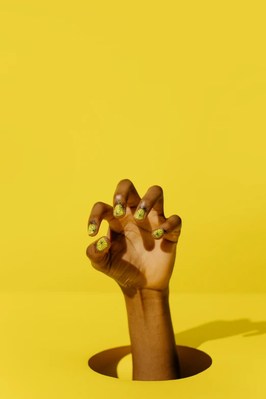 a person's hand reaching out of a hole, inspired by Barkley Hendricks, trending on pexels, glossy yellow, nails, lime green, ignant