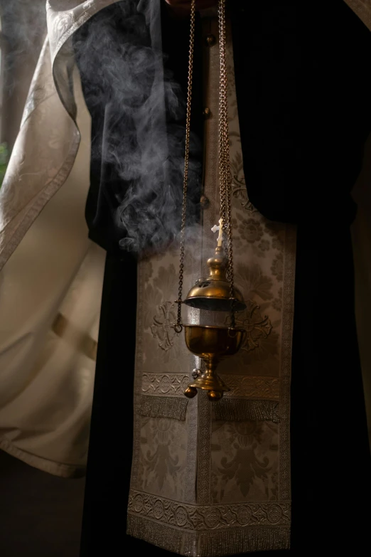a priest holding a cross with smoke coming out of it, unsplash, renaissance, ornate flowing robe, orthodox, full frame image, reliquary