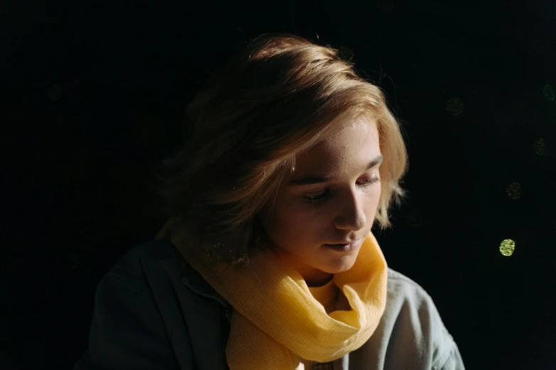 a close up of a person wearing a scarf, a character portrait, trending on pexels, medium yellow blond hair, evening lighting, studious chiaroscuro, mid shot photo