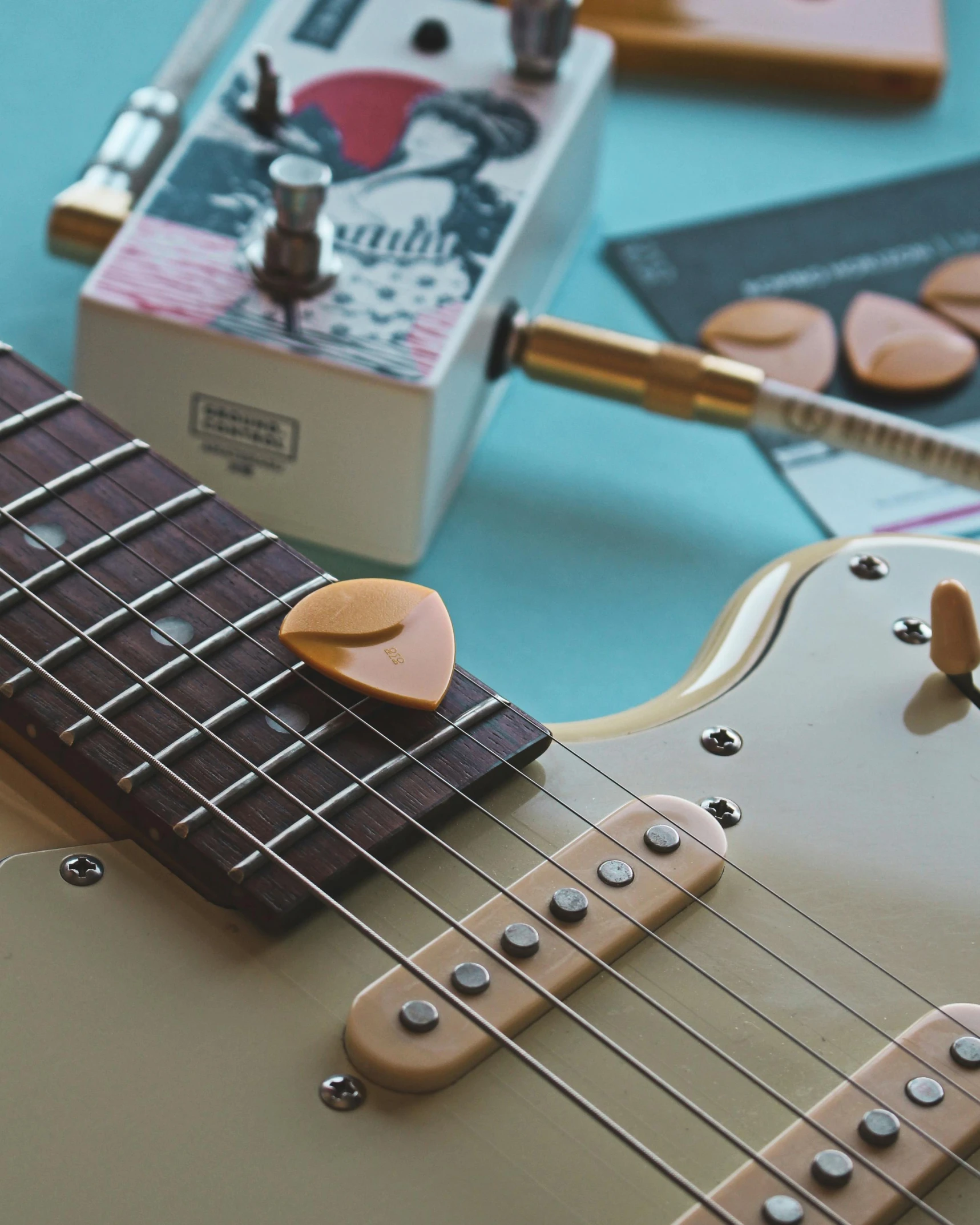 a close up of a guitar on a table, heart shaped face, adafruit, buttons, retro aesthetic