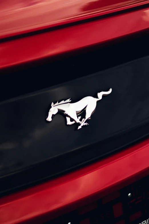 a close up of a mustang logo on a red car, renaissance, zoomed out to show entire image, white metallic, high angle, f / 2 0