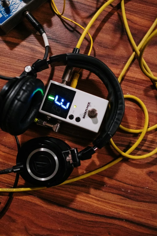 a pair of headphones sitting on top of a wooden table, by Matt Cavotta, reddit, brain computer interface, dials, stroboscope, loosely cropped