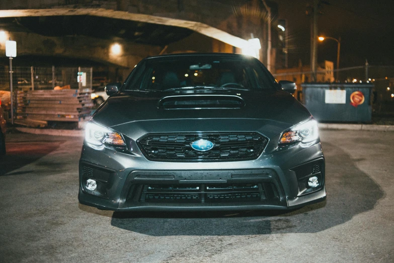 a subaruna parked in a parking lot at night, inspired by An Gyeon, wrx golf, frontal close up, oil slick, custom headlights