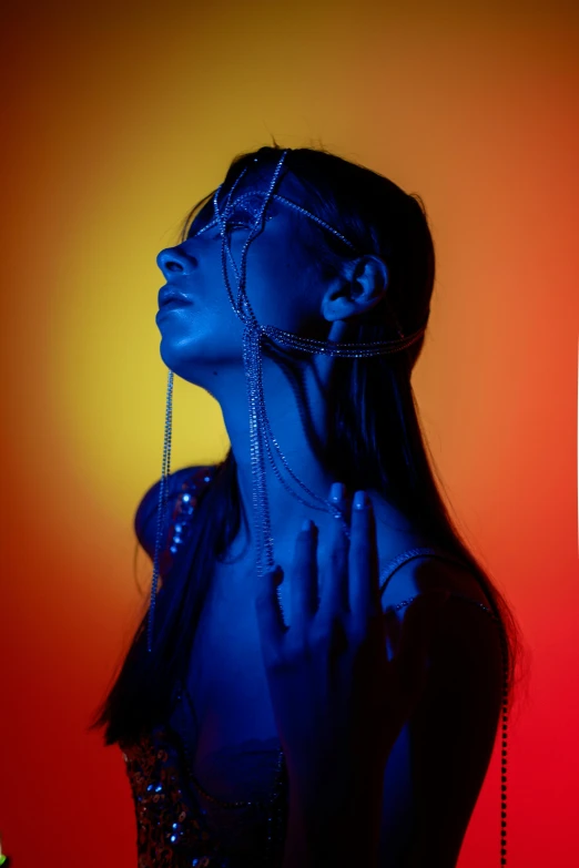 a woman with a chain around her neck, inspired by Elsa Bleda, trending on pexels, holography, blue and orange lighting, portrait of ariana grande, coloured gel studio light, profile pose