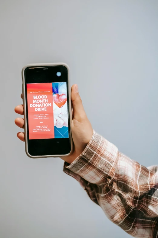 a person holding a smart phone in their hand, by Julia Pishtar, blood smear, gen z, red cross, curated collections