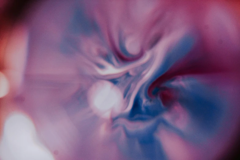 a blurry photo of a circular object, an album cover, inspired by Anna Füssli, unsplash, generative art, shades of pink and blue, chaotic storm of liquid smoke, 4 k close up, octane render - n 6