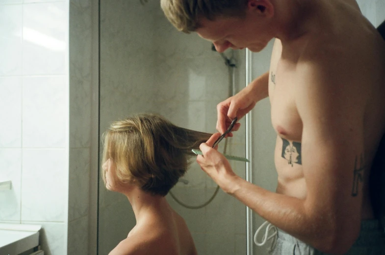 a man combing a woman's hair in a bathroom, by Elsa Bleda, pexels contest winner, hyperrealism, blond boy, teenage boy, ignant, crew cut